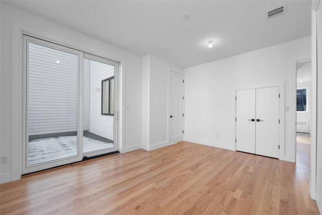 spare room with radiator and light hardwood / wood-style floors