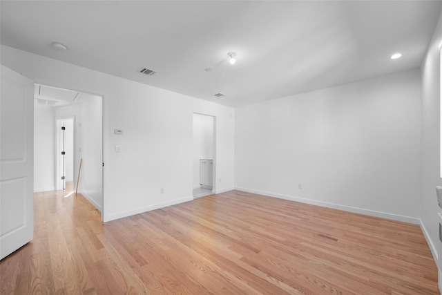 spare room with light hardwood / wood-style flooring