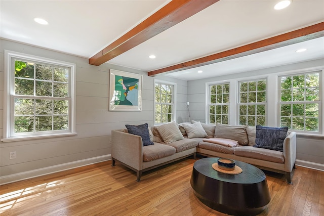 living room with beamed ceiling and light hardwood / wood-style floors