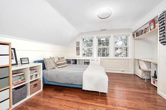 bedroom with vaulted ceiling and dark wood-type flooring