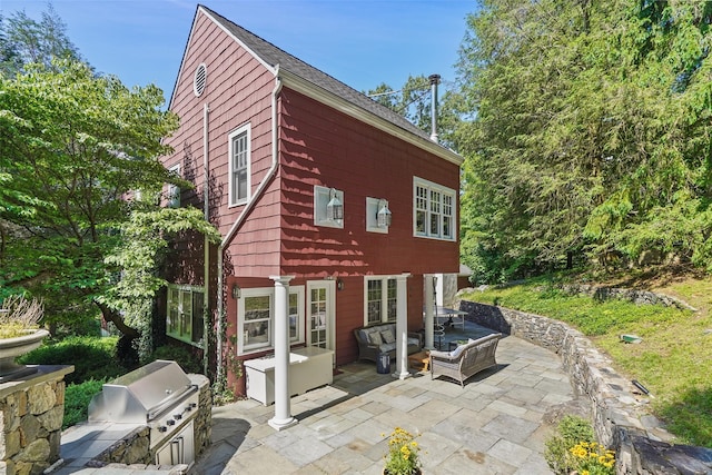 back of house with area for grilling and a patio area