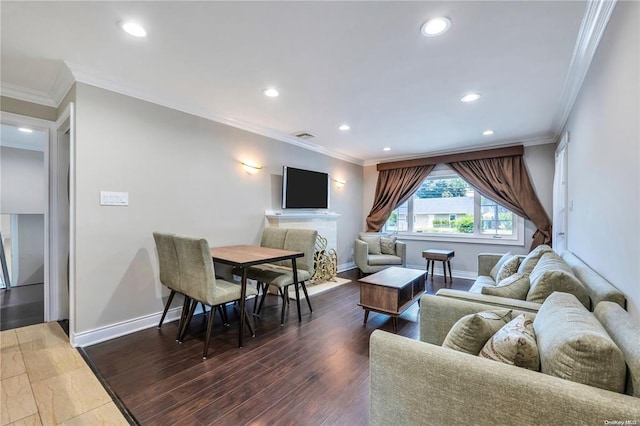 living area featuring ornamental molding, baseboards, and wood finished floors