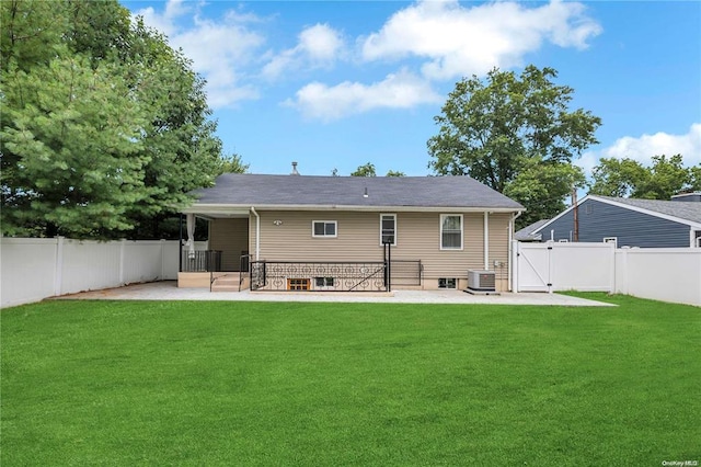 rear view of house featuring a patio, a lawn, a gate, cooling unit, and a fenced backyard