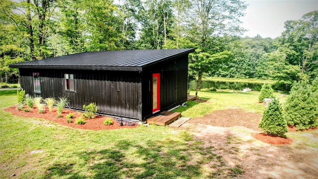 view of outdoor structure with an outbuilding and a water view