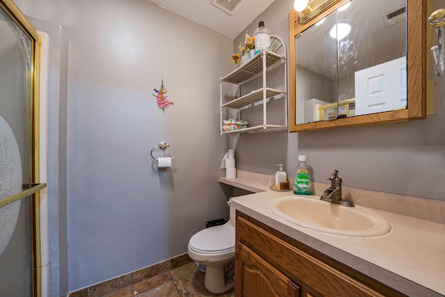 bathroom with vanity, toilet, and walk in shower