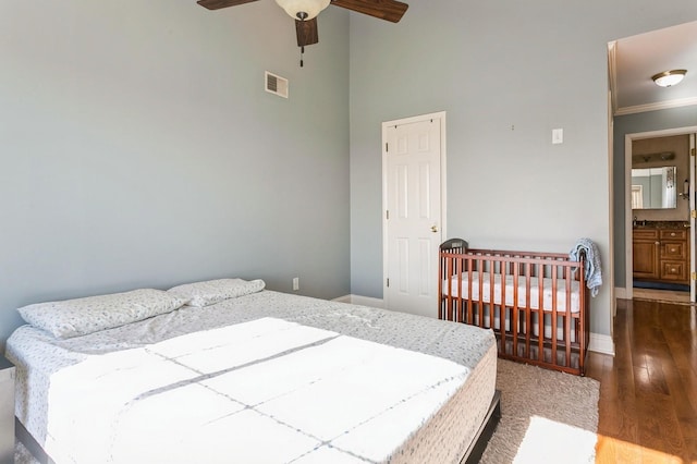 bedroom with crown molding, visible vents, dark wood-type flooring, ceiling fan, and baseboards