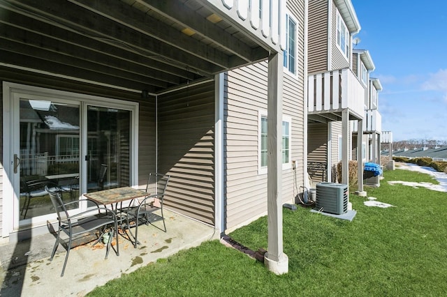 view of property exterior with a patio, central AC unit, and a lawn