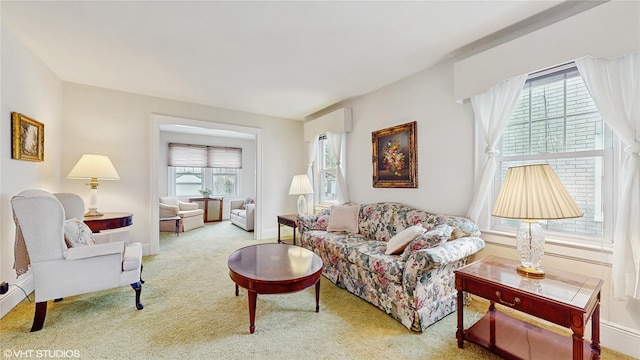 living room with carpet and baseboards