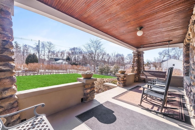 view of patio / terrace featuring fence