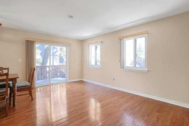 interior space featuring visible vents, baseboards, and light wood-style floors