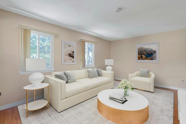 living room with light wood-style flooring and baseboards