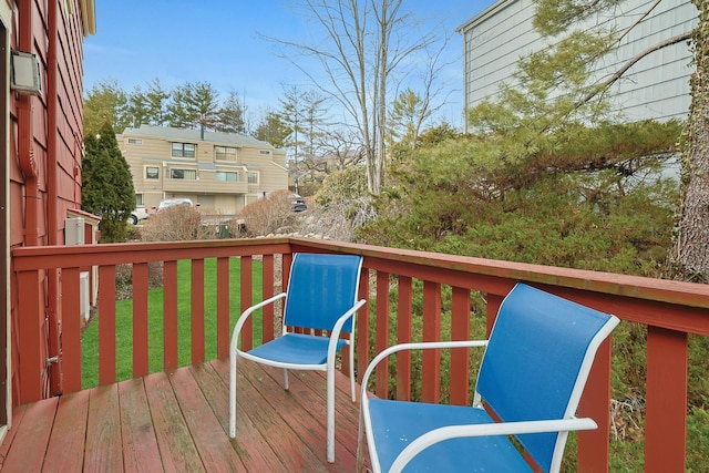 wooden terrace with a lawn