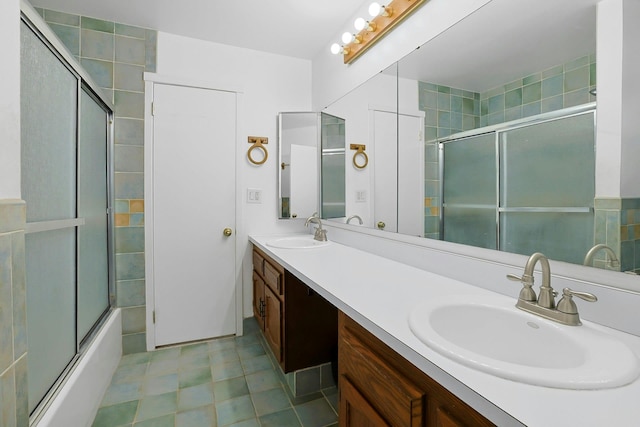 bathroom with enclosed tub / shower combo, double vanity, and a sink