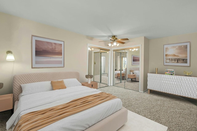 carpeted bedroom with a ceiling fan and multiple closets