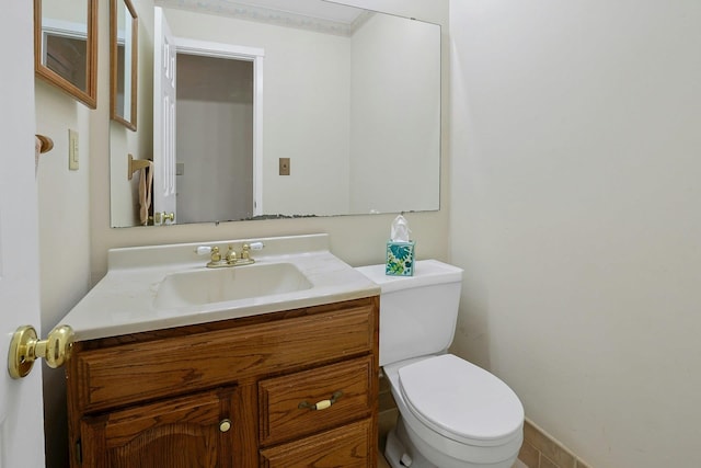 half bathroom with toilet and vanity