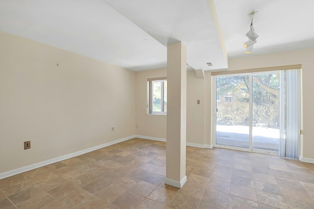 unfurnished room with visible vents and baseboards