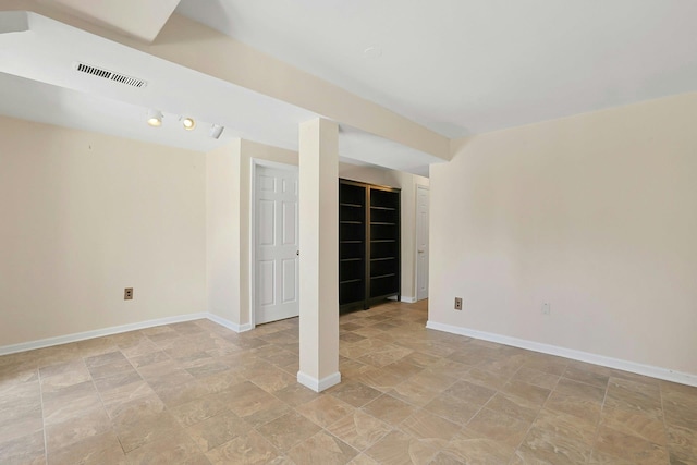 empty room featuring visible vents and baseboards