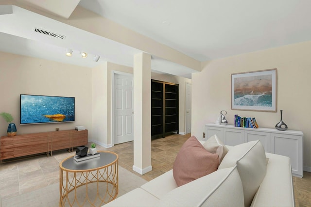 living area featuring visible vents and baseboards