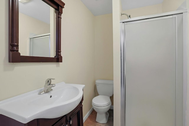 bathroom with tile patterned flooring, baseboards, toilet, a stall shower, and vanity