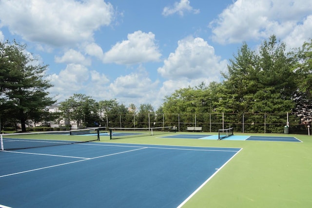 view of tennis court featuring fence