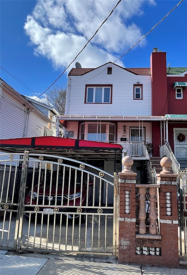 view of property with a porch and a gate