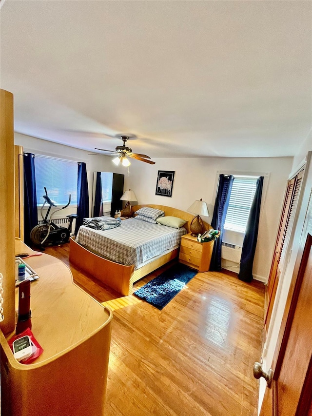 bedroom with light hardwood / wood-style flooring and ceiling fan