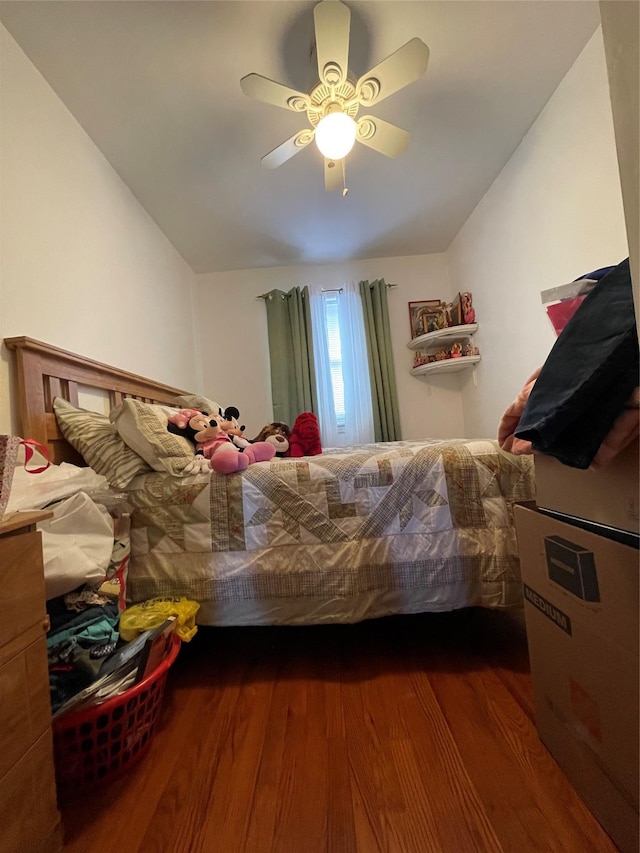 bedroom featuring hardwood / wood-style flooring, ceiling fan, and lofted ceiling