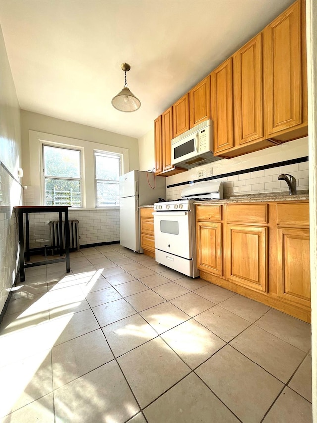 kitchen featuring white appliances, hanging light fixtures, decorative backsplash, and light tile patterned floors