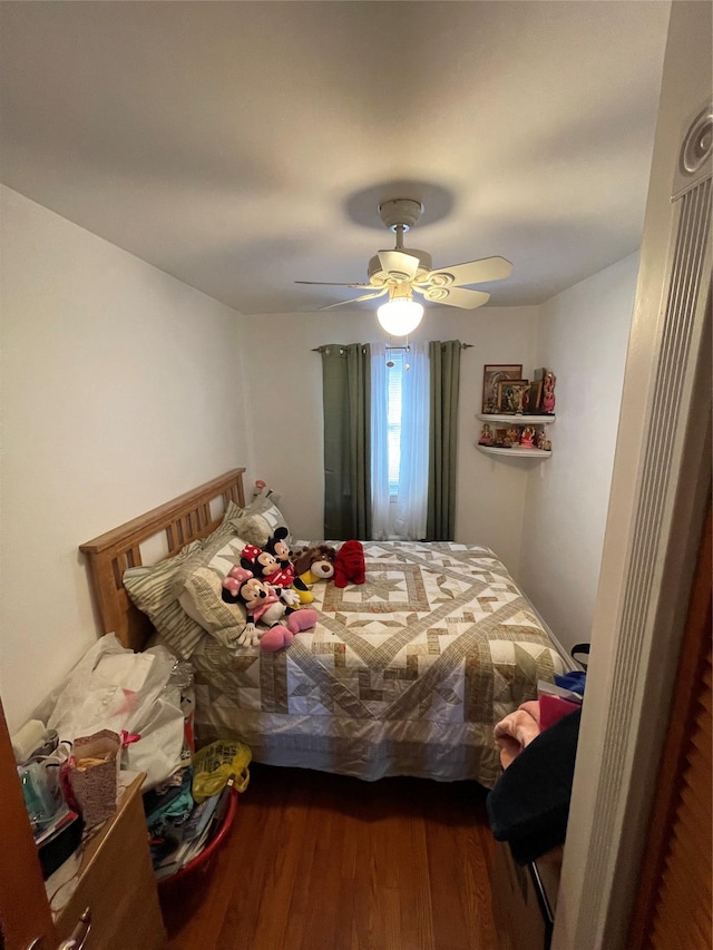 bedroom with hardwood / wood-style floors and ceiling fan