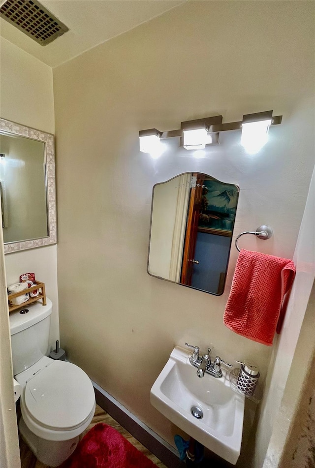 bathroom featuring sink and toilet