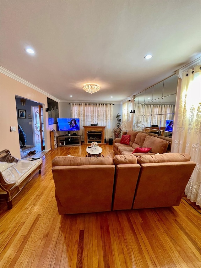 living room with ornamental molding and hardwood / wood-style flooring