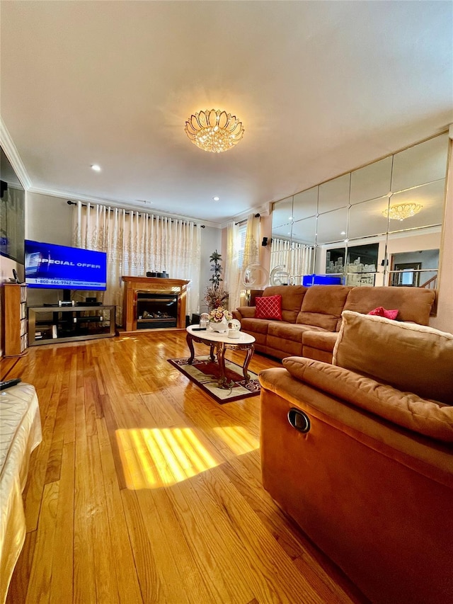 living room with hardwood / wood-style floors and crown molding