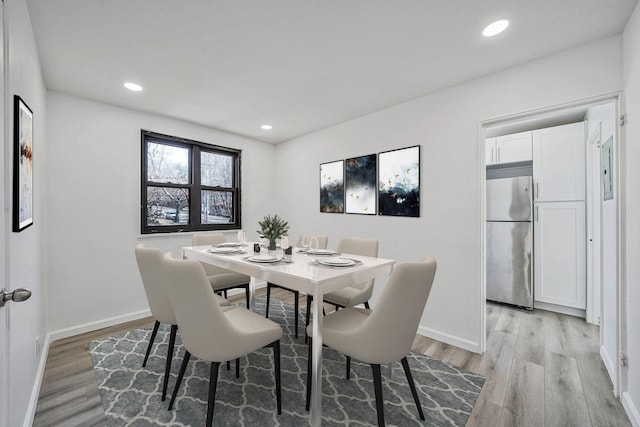 dining area featuring light wood-type flooring