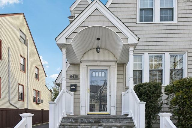 doorway to property featuring cooling unit and fence