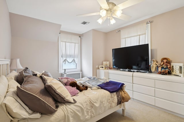 carpeted bedroom with ceiling fan and visible vents