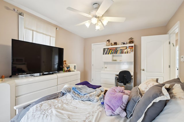 bedroom with ceiling fan and built in study area