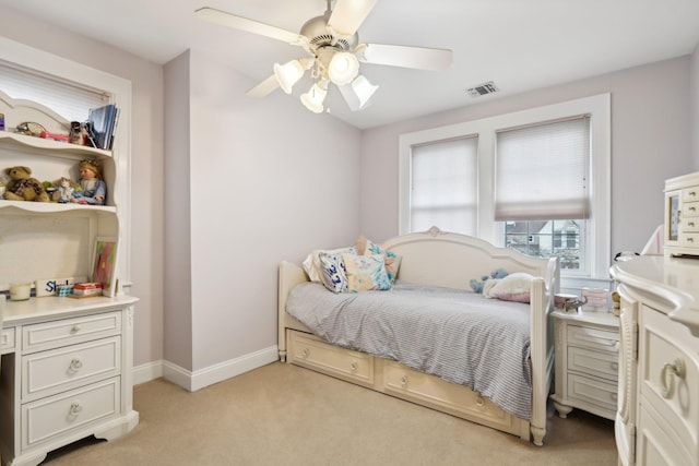 bedroom with light carpet, baseboards, visible vents, and ceiling fan