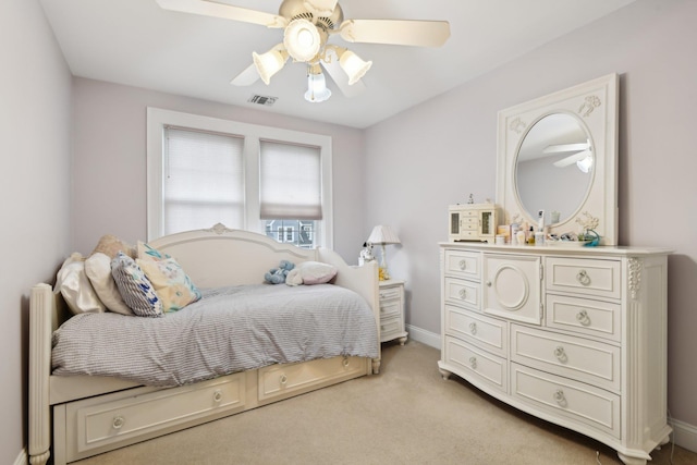 bedroom featuring light carpet, baseboards, visible vents, and a ceiling fan