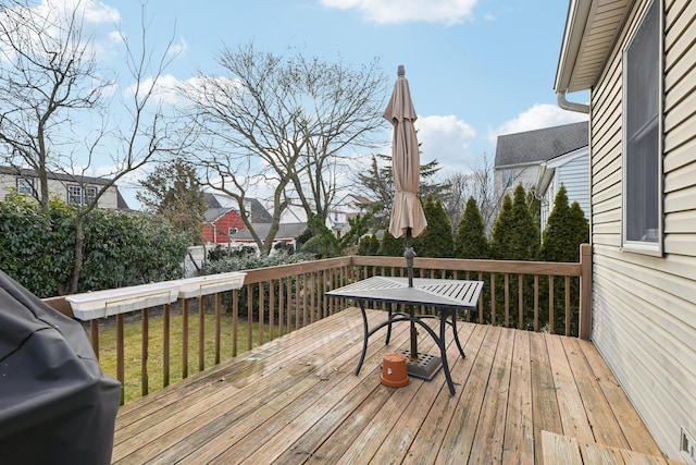 wooden deck featuring a lawn