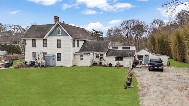 view of front facade with dirt driveway, a shingled roof, a chimney, and a front yard