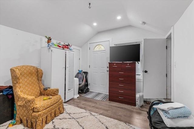 sitting room featuring lofted ceiling, wood finished floors, and recessed lighting