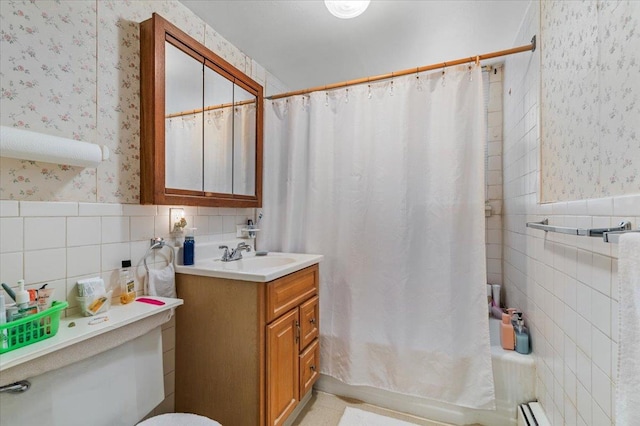 bathroom featuring shower / tub combo with curtain, wainscoting, tile walls, and wallpapered walls