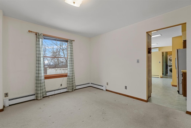 carpeted empty room featuring baseboard heating