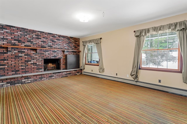 unfurnished living room featuring a brick fireplace, a healthy amount of sunlight, carpet flooring, and a baseboard radiator