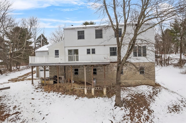 snow covered property featuring a wooden deck