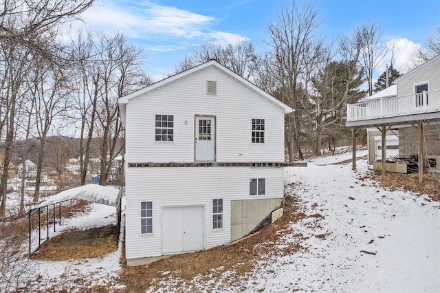 view of snow covered back of property