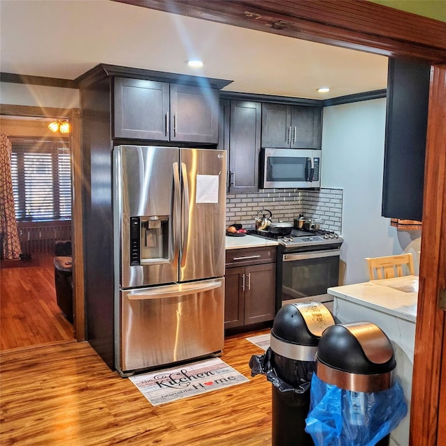 554 Grant Ave, West Hempstead, NY 11552 - kitchen featuring light countertops, stainless steel appliances, light wood-style floors, and tasteful backsplash