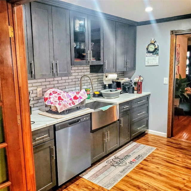 554 Grant Ave, West Hempstead, NY 11552 - kitchen with light countertops, dishwasher, tasteful backsplash, a sink, and light wood-type flooring