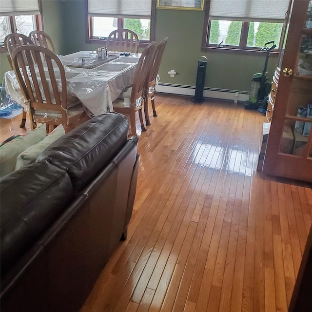 554 Grant Ave, West Hempstead, NY 11552 - dining room featuring plenty of natural light, hardwood / wood-style flooring, and baseboard heating