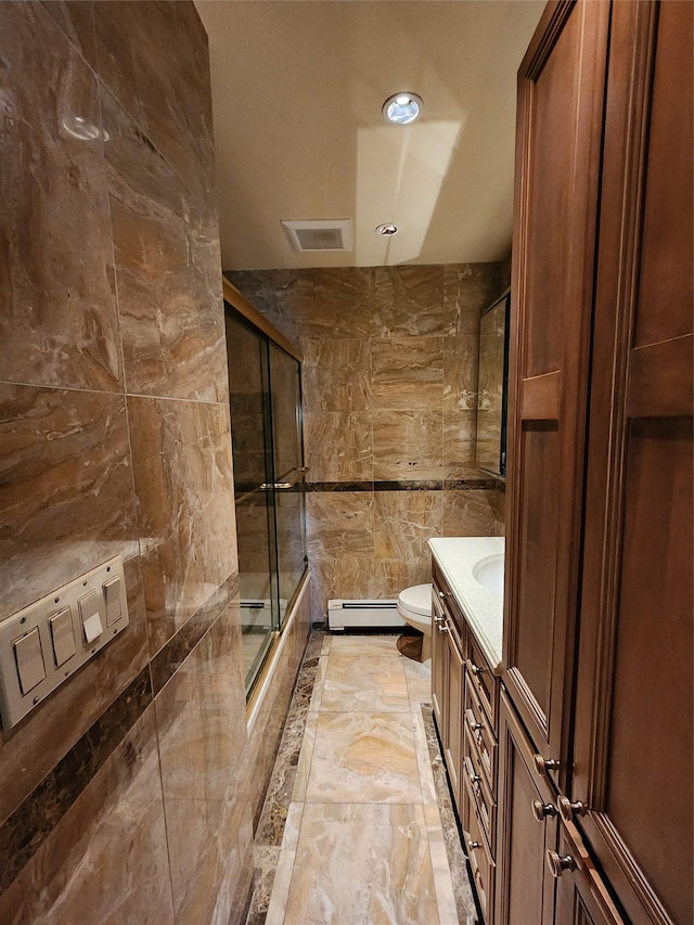 bathroom with tile walls, vanity, toilet, and a baseboard radiator